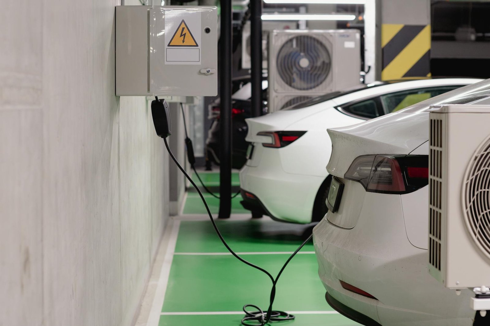 Des véhicules électriques chargeant dans une station intérieure dans un garage souterrain moderne.